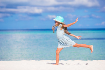Adorable little girl during beach vacation having fun
