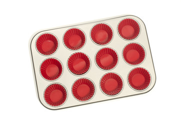 Cupcake tray with red silicone liners.Muffin metal tray isolated
