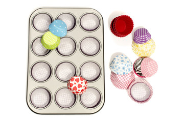 Metal cupcake tray with all colors paper and silicone liners.