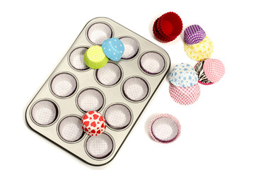 Metal cupcake tray with all colors paper and silicone liners.