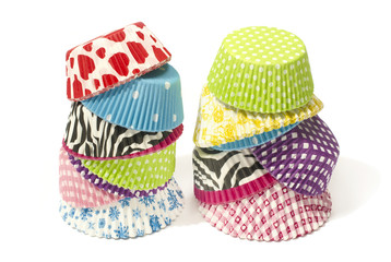 Piles of all colors cupcake paper cups. Muffins liners isolated.