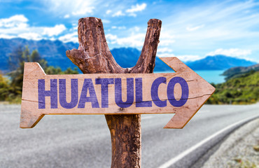Huatulco wooden sign with road background