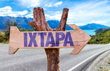 Ixtapa wooden sign with road background