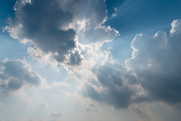 Beautiful background bright sun shines through clouds, light ray