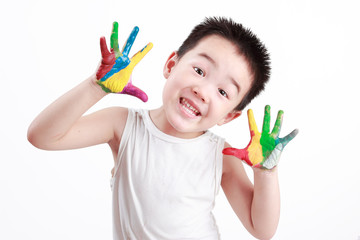 Chinese boy painting with hands with different color paint on his palms