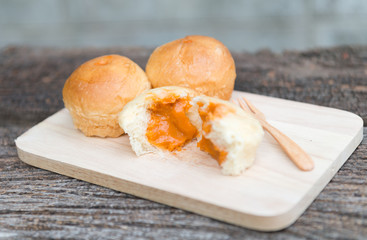 Half of bread milk tea custard filling on wood plate