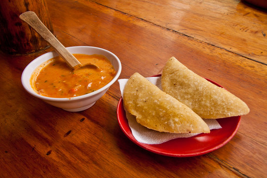 Morocho empanadas served with chilli sauce