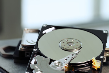 Obraz premium Close up of open computer hard disk drive on notebook