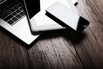 keyboard with phone and tablet pc on wooden desk