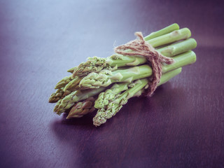 asparagus on wooden table with filter effect retro vintage style