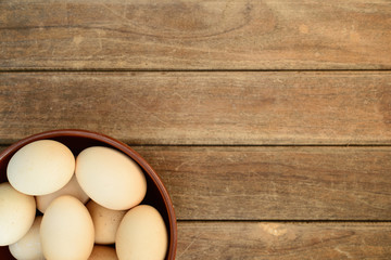 Egg in dish on old wooden table background
