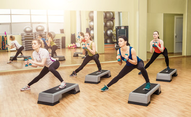 Group of women making step aerobics