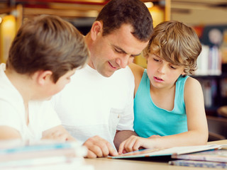 Father with sons in library