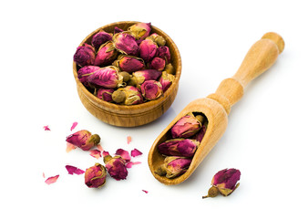 Buds of dried roses for tea in a wooden bowl