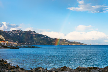 view of Giardini Naxos town, cape and rainbow