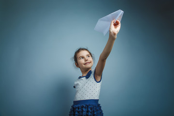 a girl of seven European appearance brunette holding a paper air