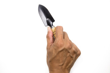 A hand holds out a garden shovel