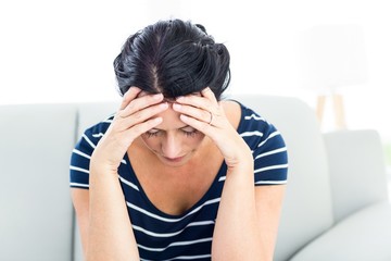 Unhappy woman sitting on the couch