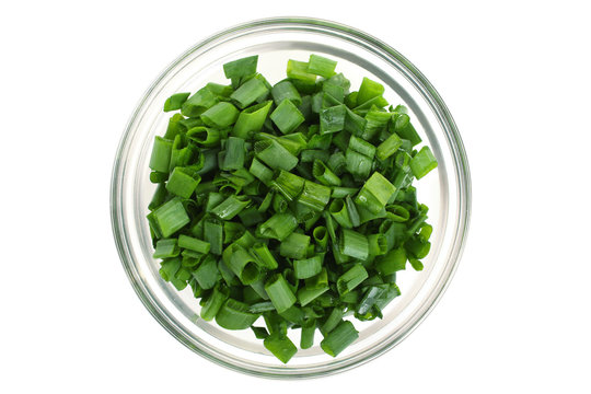 chopped green onions in a bowl isolated