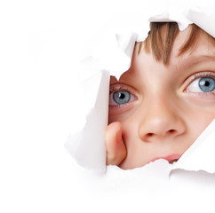 little girl looking out of a hole in a paper