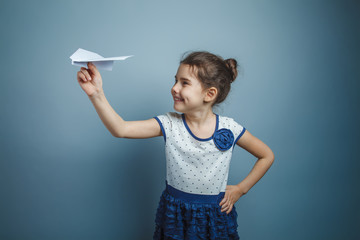 a girl of seven European appearance brunette holding a paper air