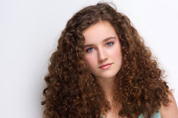 Elegant teenage girl with long curly hair