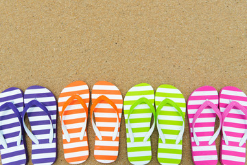 Multicolor sandals on beach