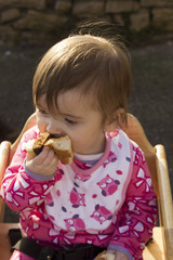 one year old baby eating a burger