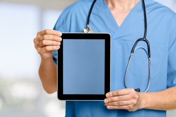 Blank. Doctor working with tablet computer with operating room