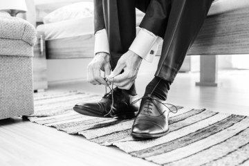Groom putting on shoes