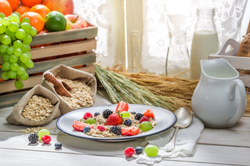 Tasty oatmeal with fresh fruits for breakfast