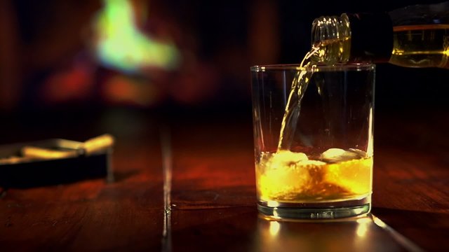 Pouring a scotch whiskey on the rocks