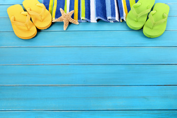 Beach background border summer vacation holiday with flip flop sandals accessories on old blue wood planked decking in a row line space for copy text photo