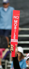 Man hold sign No Mobile Please.