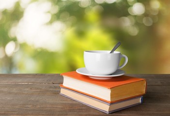 Tea. Cup of coffee and book on wooden table
