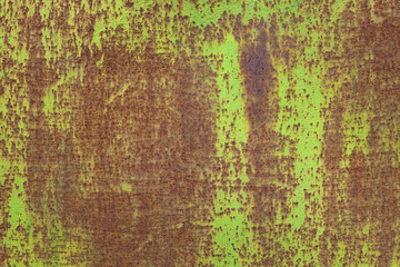 red rusted on the green yellow metal wall.Texture