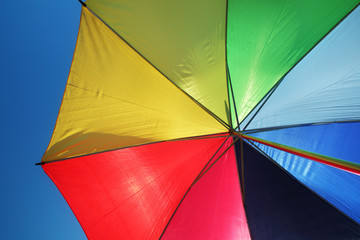 Rainbow umbrella and sky background