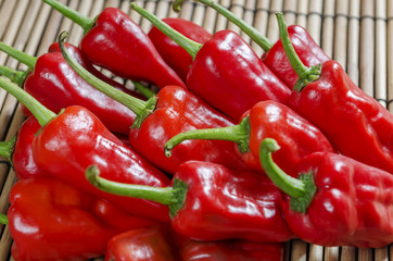 fresh red chilies on wooden bamboo display