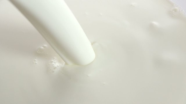 Pouring milk closeup