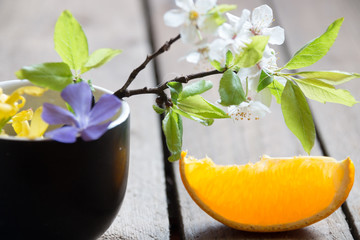 leaves and orange slice on wooden table