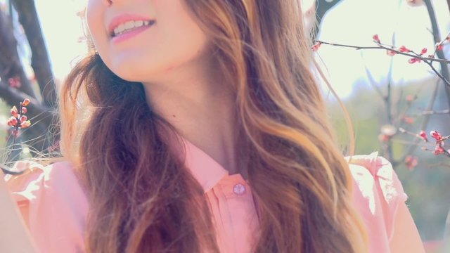 Young woman in spring orchard