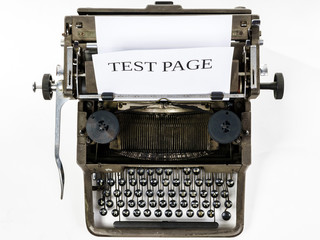 Old vintage typewriter with blank paper sheet