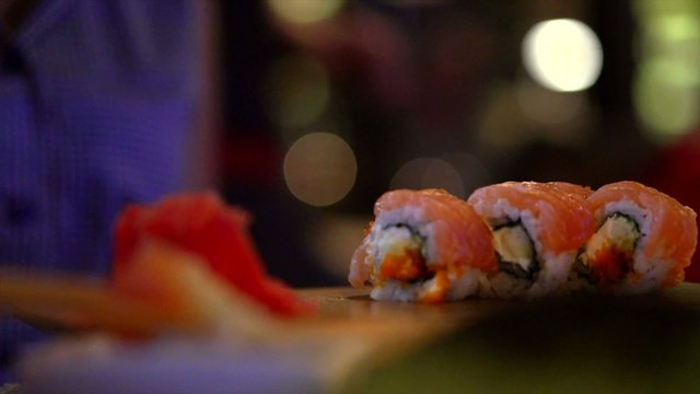 Young woman eating sushi rolls. Full HD video  1080p