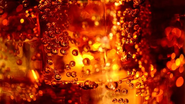 Cola with ice and bubbles in glass. Slow motion. Full HD 1080p