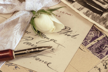 alte Postkarte mit Schreibfeder und Rose