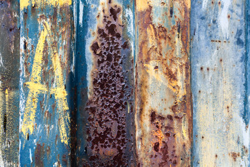 red rusted on the color metal wall with planks. Texture