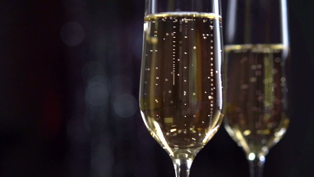 Flutes with sparkling champagne closeup. Slow motion full HD