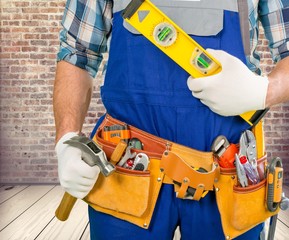 Handyman. Handyman with a tool belt. Isolated on white