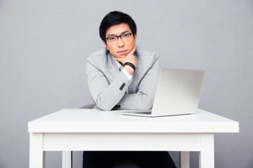 Businessman sitting at the table with laptop