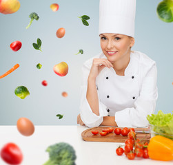 smiling female chef with vegetables